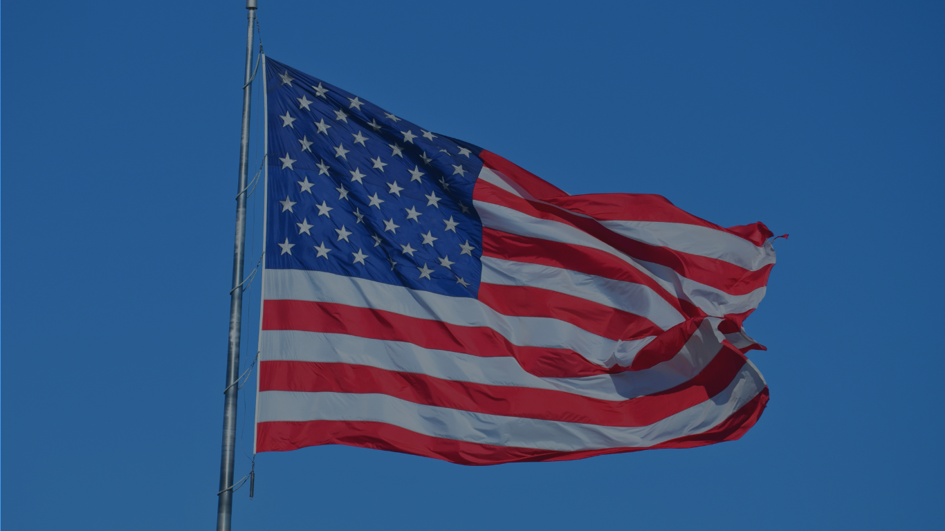 US flag flying in the wind. Illustrating import challenges for clinical trials in the USA.